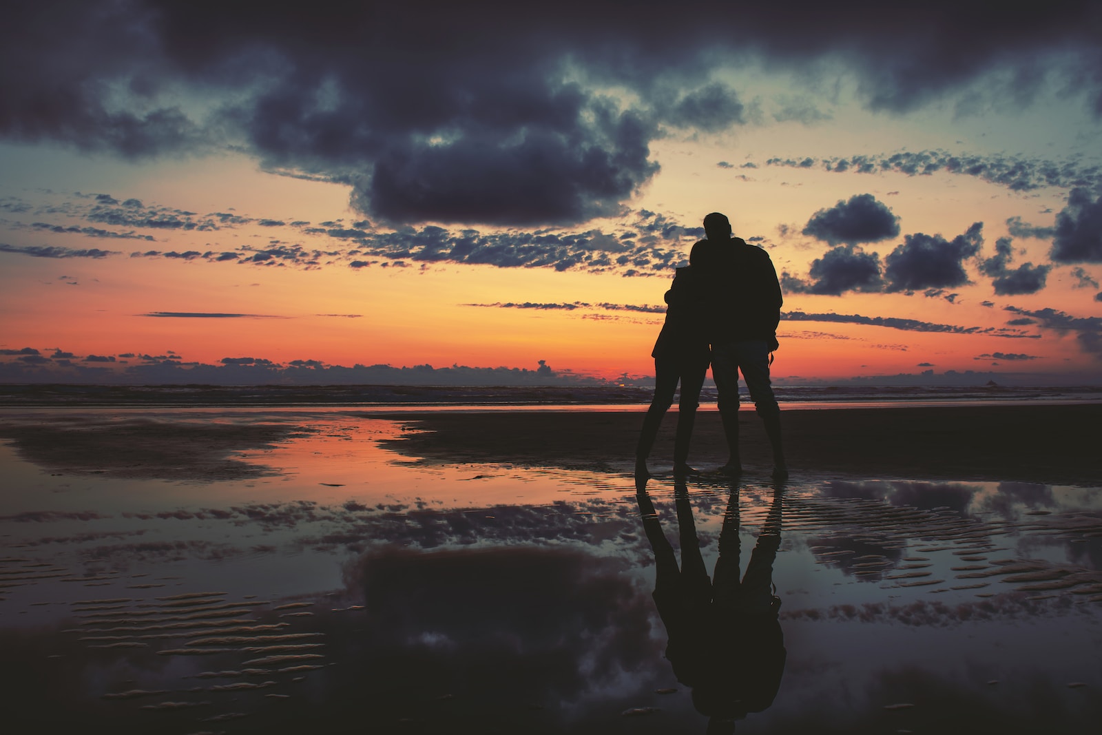 Photo of silhouette of two person standing near seashore for "When God Calls Your Name" Blog Post